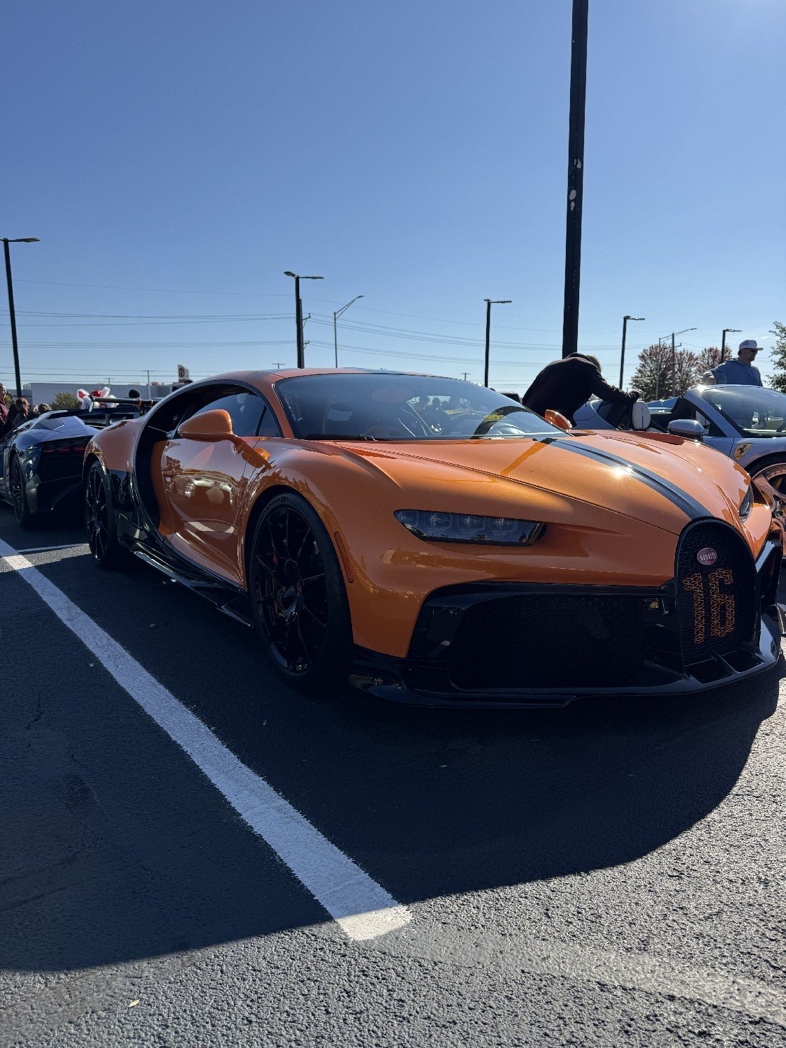 An orange Bugatti supercar at the Cars & Candy show