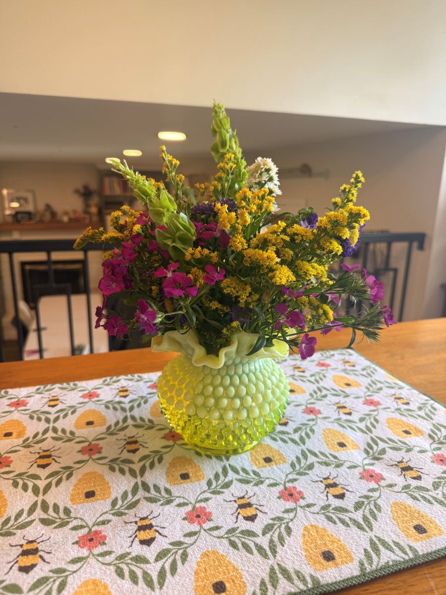 Wildflower arrangement in a green hobnail vase