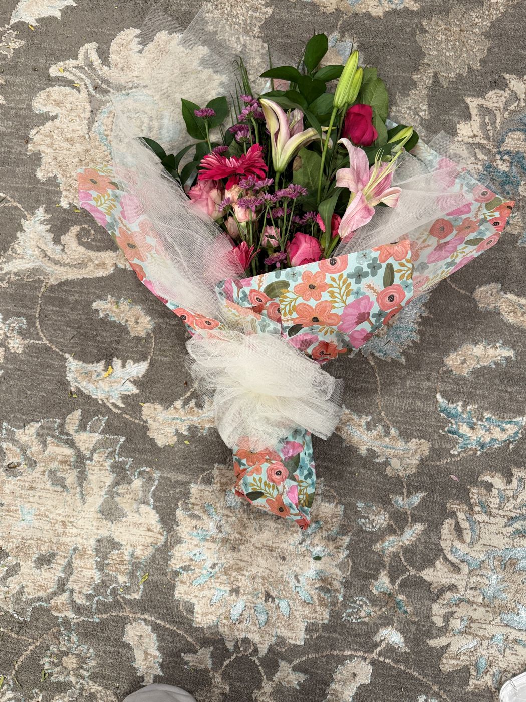 A hand-tied wrapped bouquet in floral paper