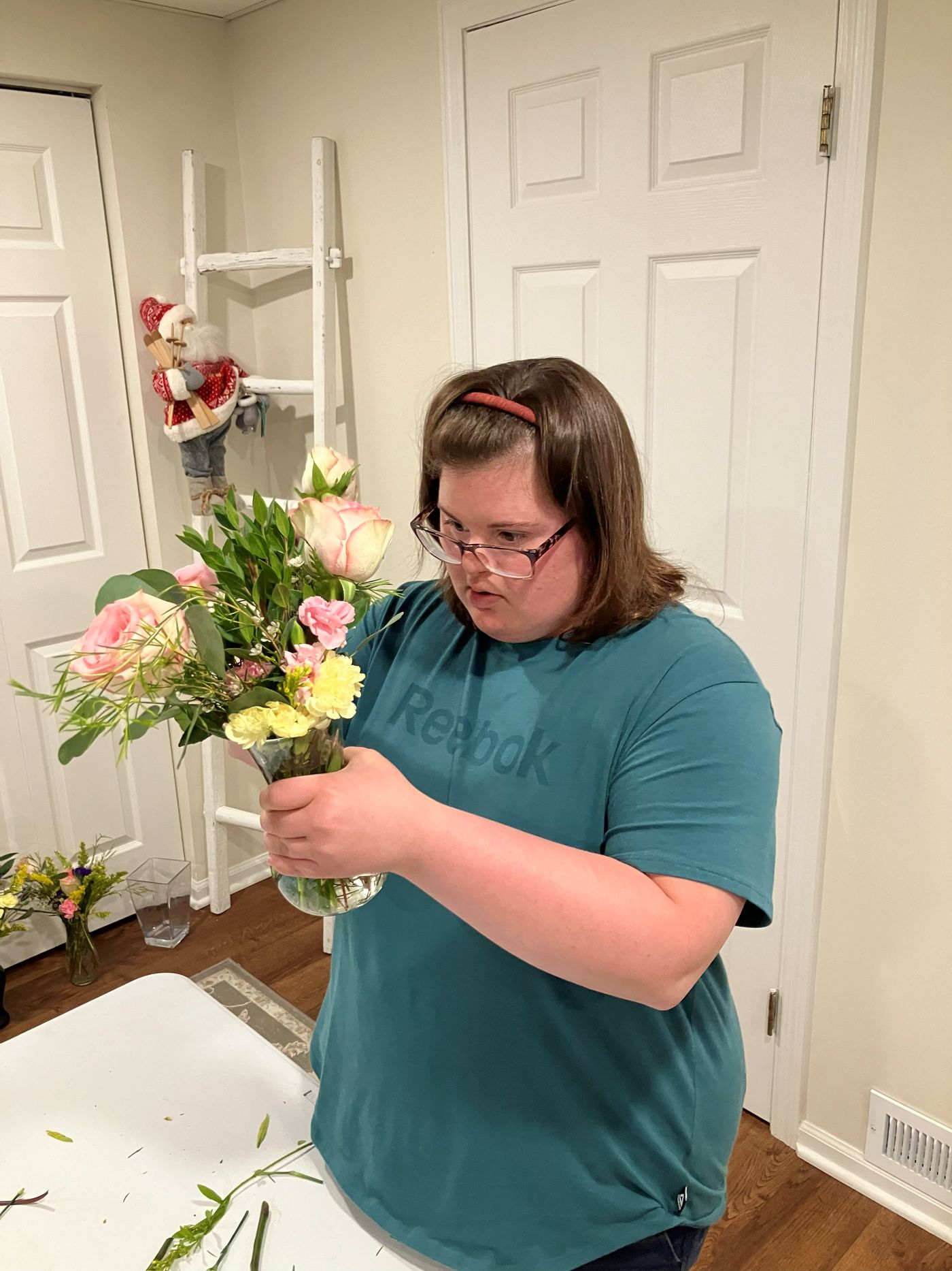 A floral team member arranging flowers at the studio table