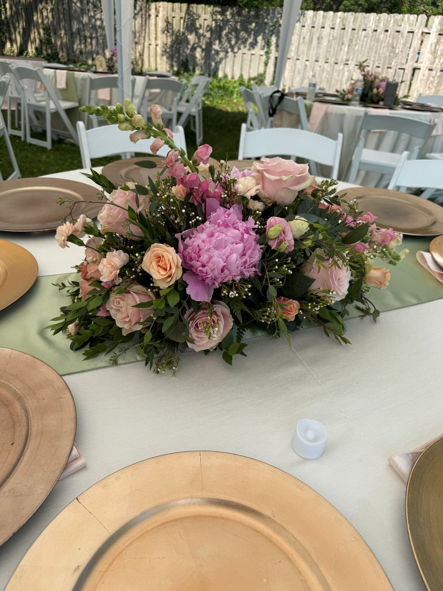 Blush garden centerpiece on a set reception table
